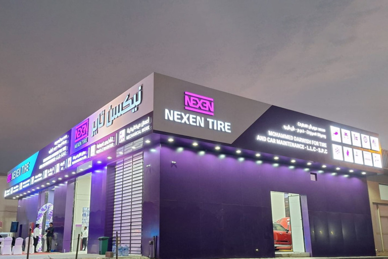NEXEN TIRE branded shop exterior showcasing purple signage and global brand identity rollout