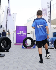 NEXEN Tires fan activation football challenge zone at Al Nasr Stadium Dubai with supporters participating in tire goal games