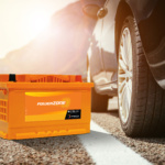 A set of high-performance summer tyres and a powerzone car battery displayed together, representing essential UAE summer vehicle maintenance.