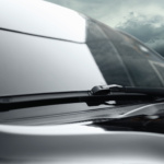 A car driving on Sheikh Zayed Road (E11) with clean windshield wipers installed by Saeedi Pro.