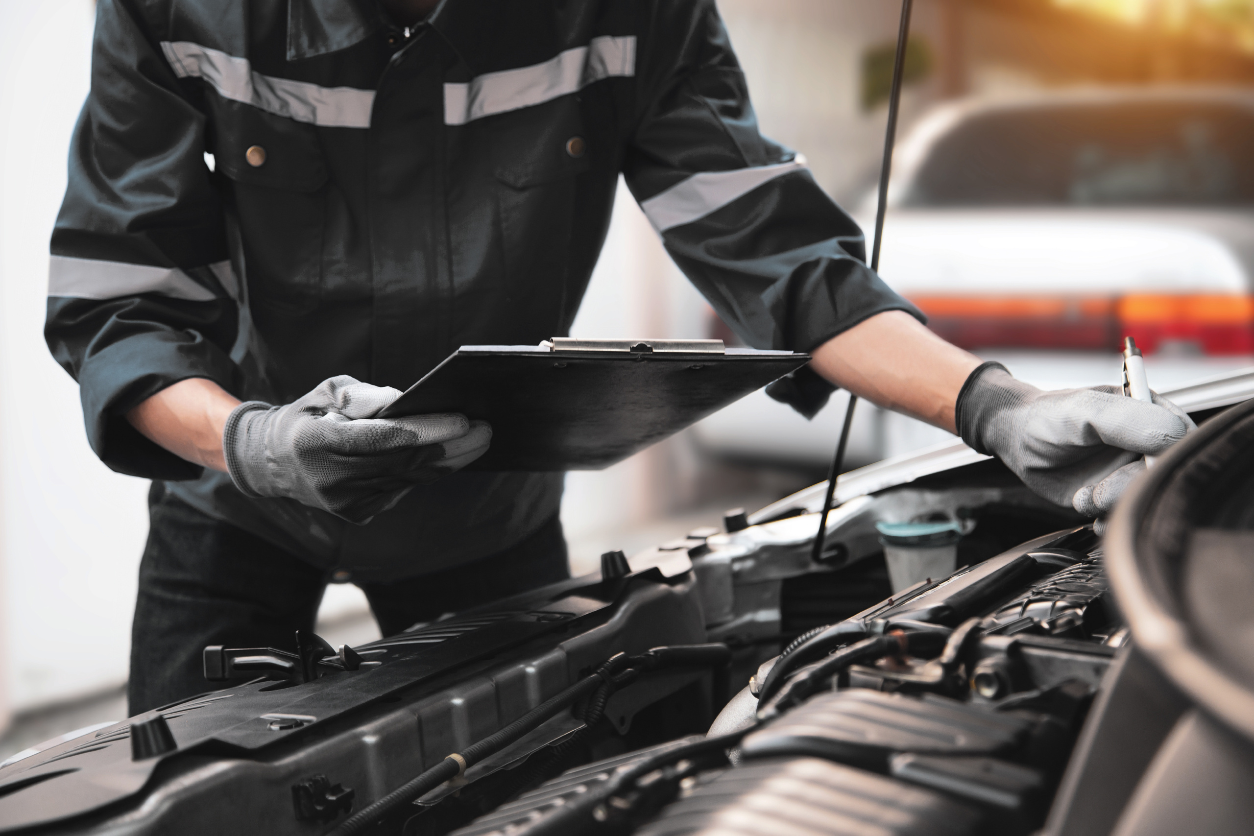 Technician installing Bosch wiper blades and performing a car AC gas refill for a vehicle in the UAE