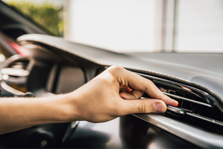 Technician servicing a car air conditioning system in Dubai