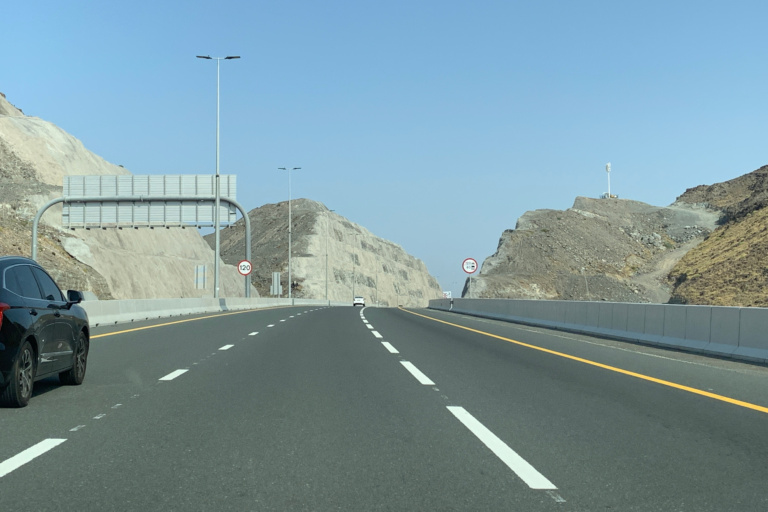 Car on a desert highway during a UAE summer road trip